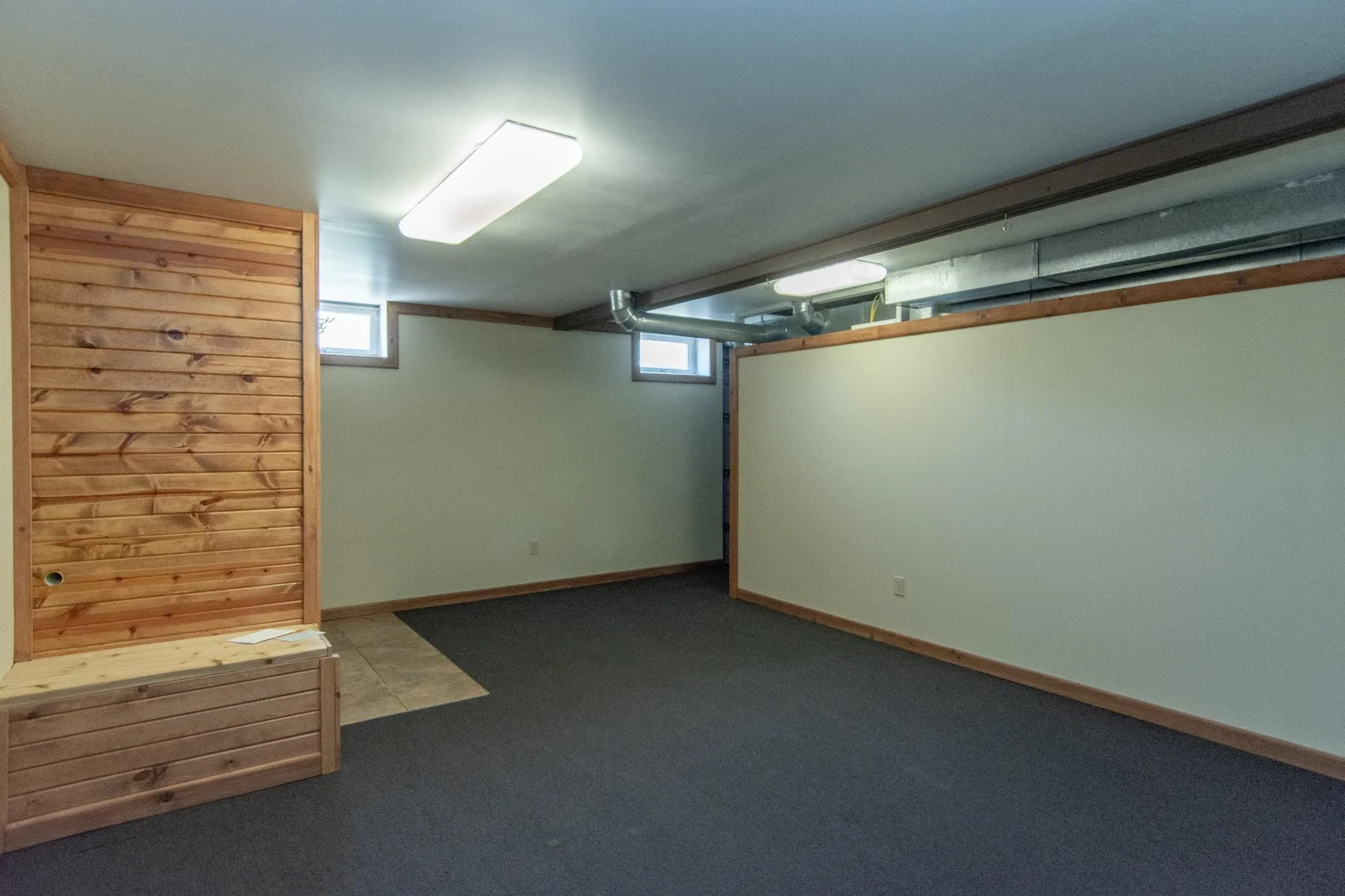 Bedroom or exercise room has a carpeted floor, a sauna, and a 5x18 space behind the south wall that is currently being used as a workspace or craft room.  New photo coming of the egress window that was just installed.