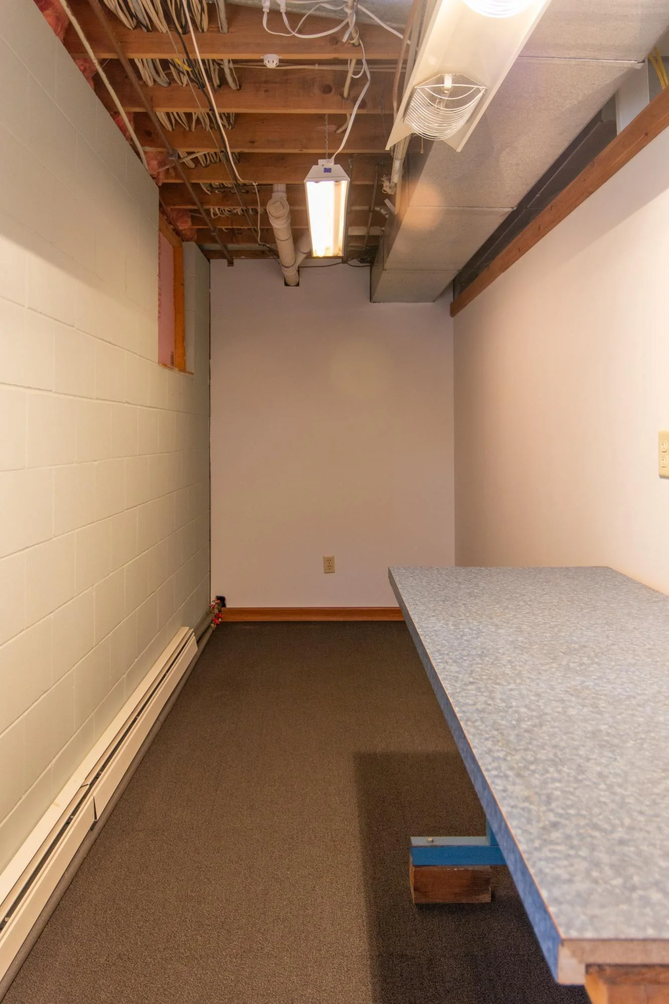 This space in the bedroom or exercise room is currently being used as a workspace or craft area.