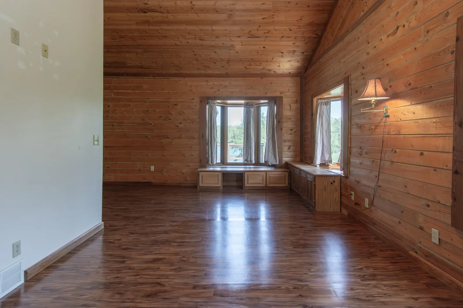The primary bedroom has a vinyl floor, four closets with the largest measuring 2.5x8 ft., a ceiling fan, private full bathroom and windows facing east and south.