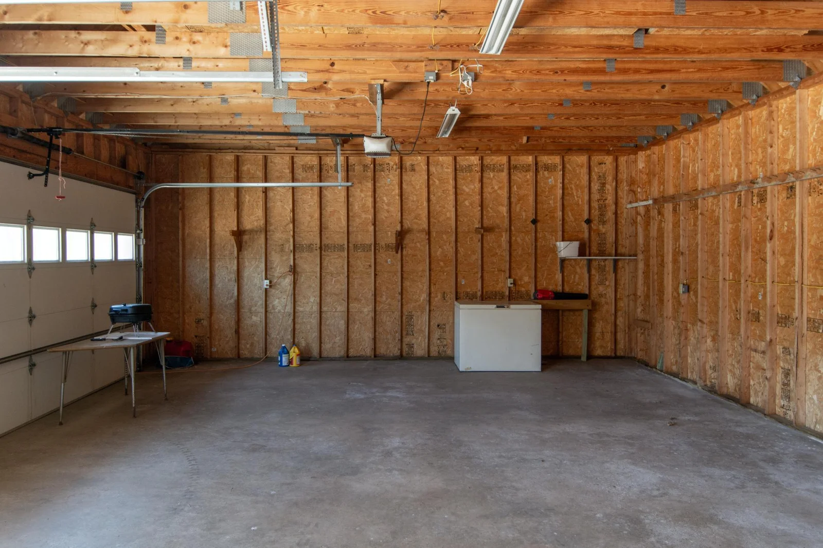 4 stall garage has a cement floor.