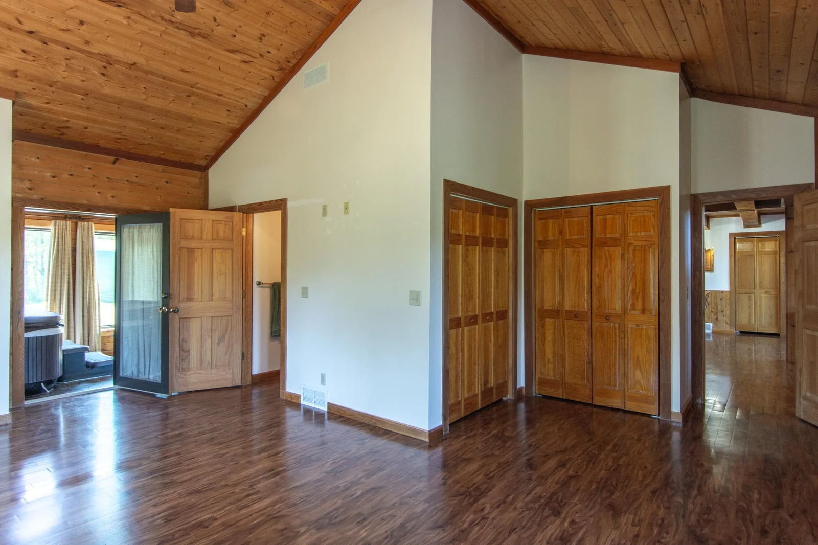The primary bedroom has a vinyl floor, four closets with the largest measuring 2.5x8 ft., a ceiling fan, private full bathroom and windows facing east and south.