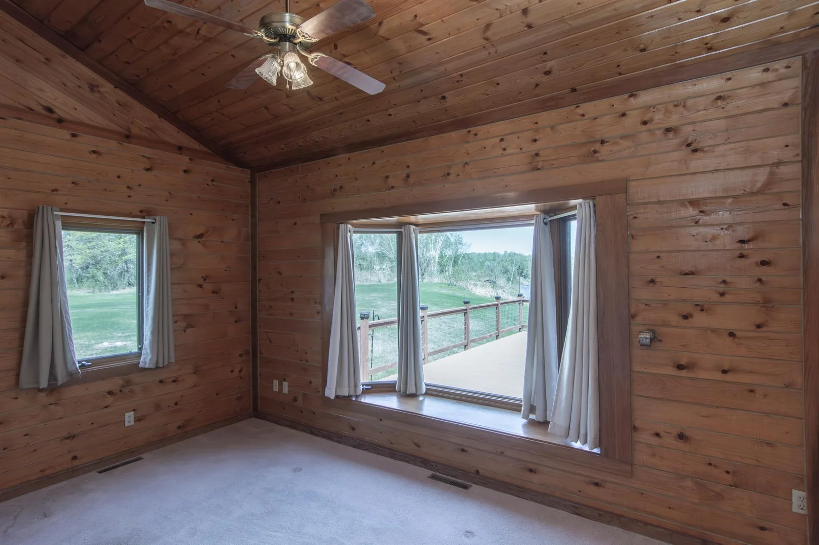 Bedroom 2 has a carpeted floor, a ceiling fan, a 2x4.5 ft. closet, and windows facing east and north.