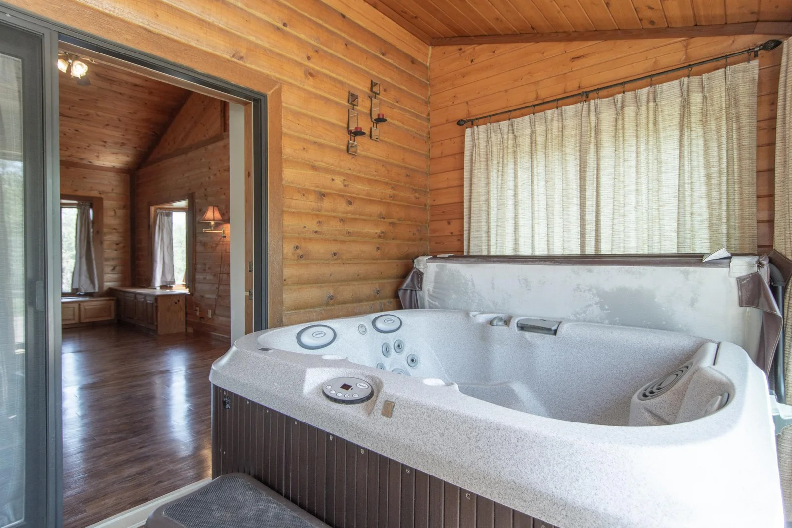 Access to the four-season porch and hot tub from the primary bedroom.