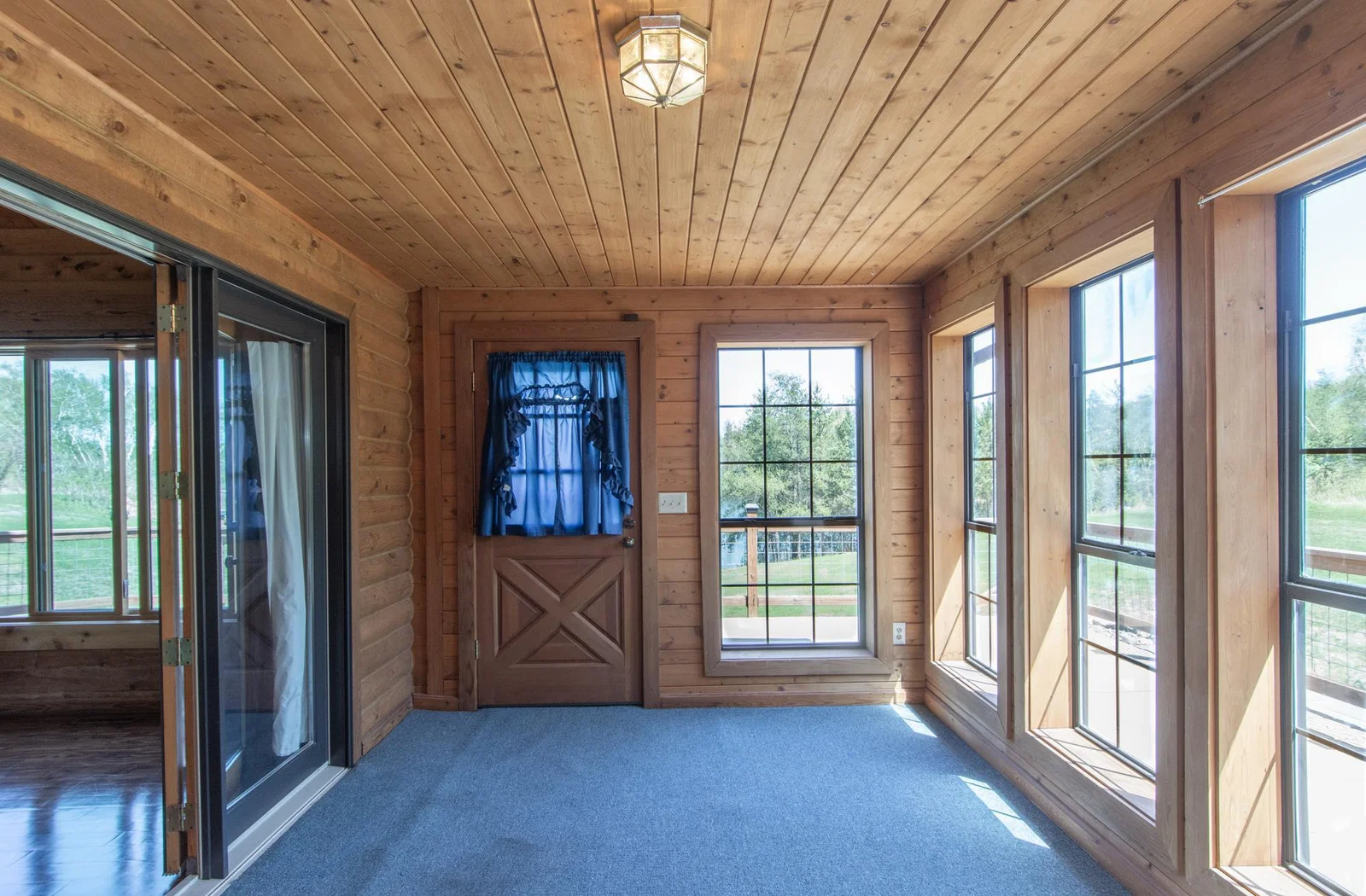 The 3 Season Porch has a carpeted floor and windows facing south and east. There is deck access from the porch.