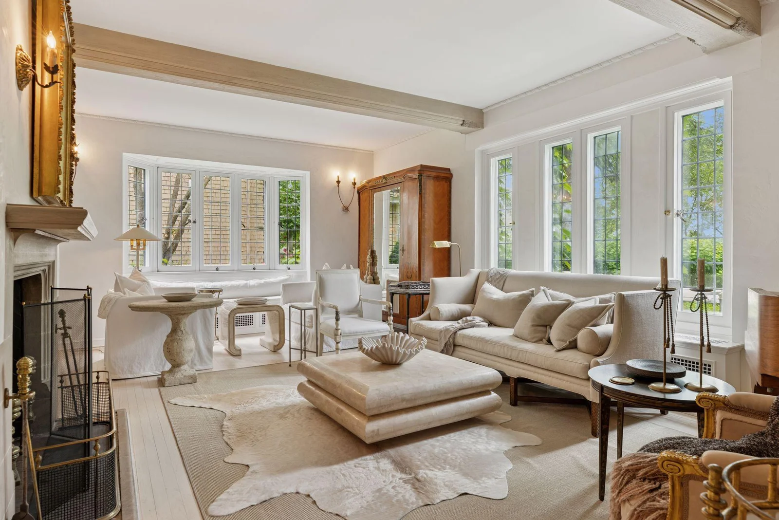 Spacious living room with southern and western exposure and a large wood-burning fireplace.