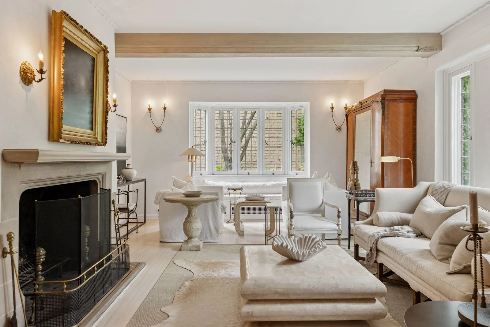 The living room features 10' ceilings, wood beam ceiling, decorative plaster molding, built-in window seat, and concrete surround fireplace.
