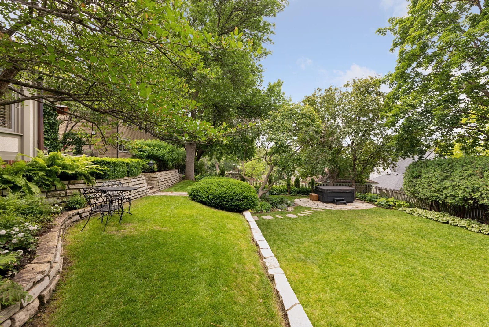 Raised garden beds and a terraced upper and lower lawn.