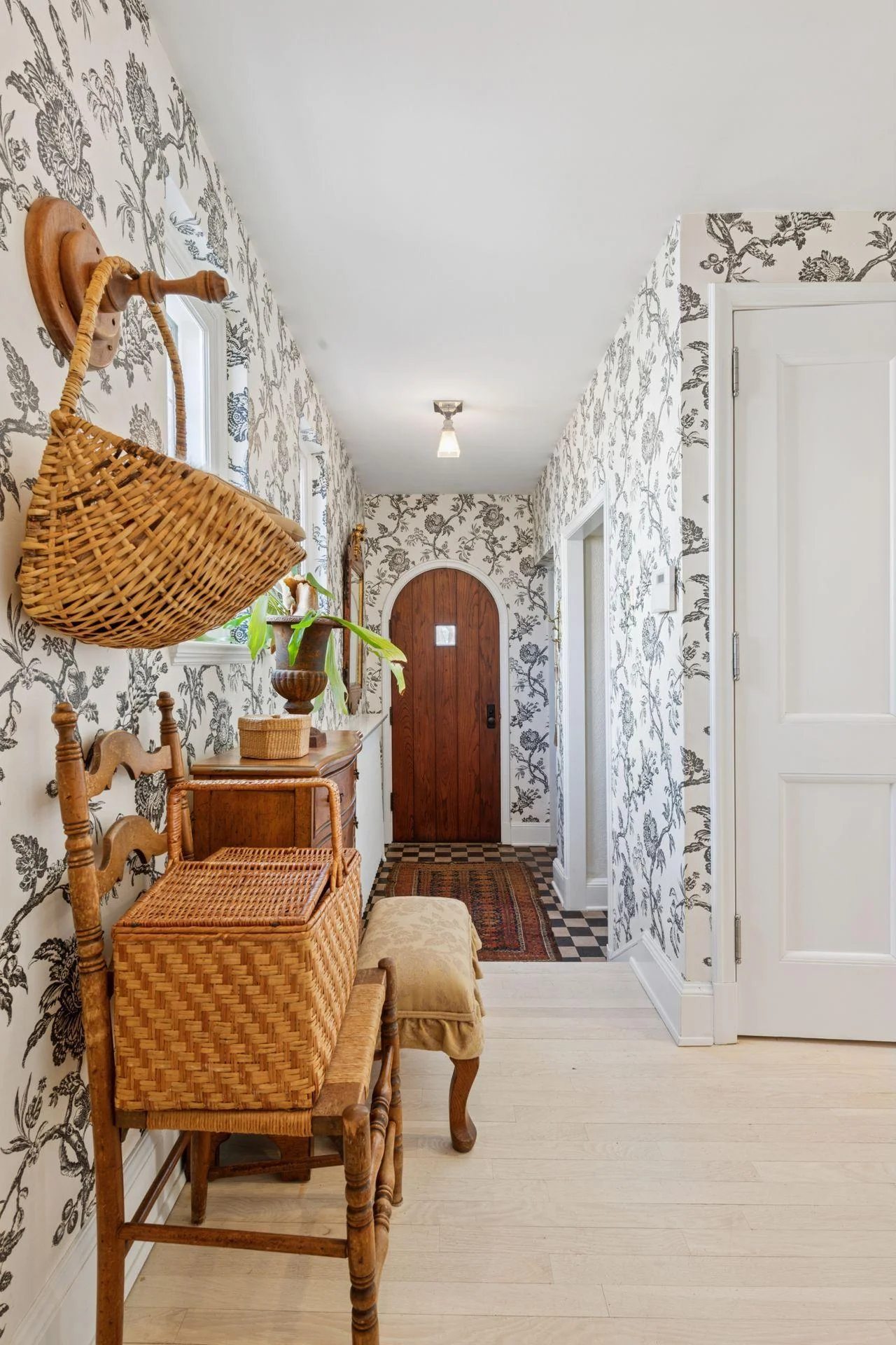 Mud room and back hall with access to side door, garage entrance, and secondary staircase to lower level.