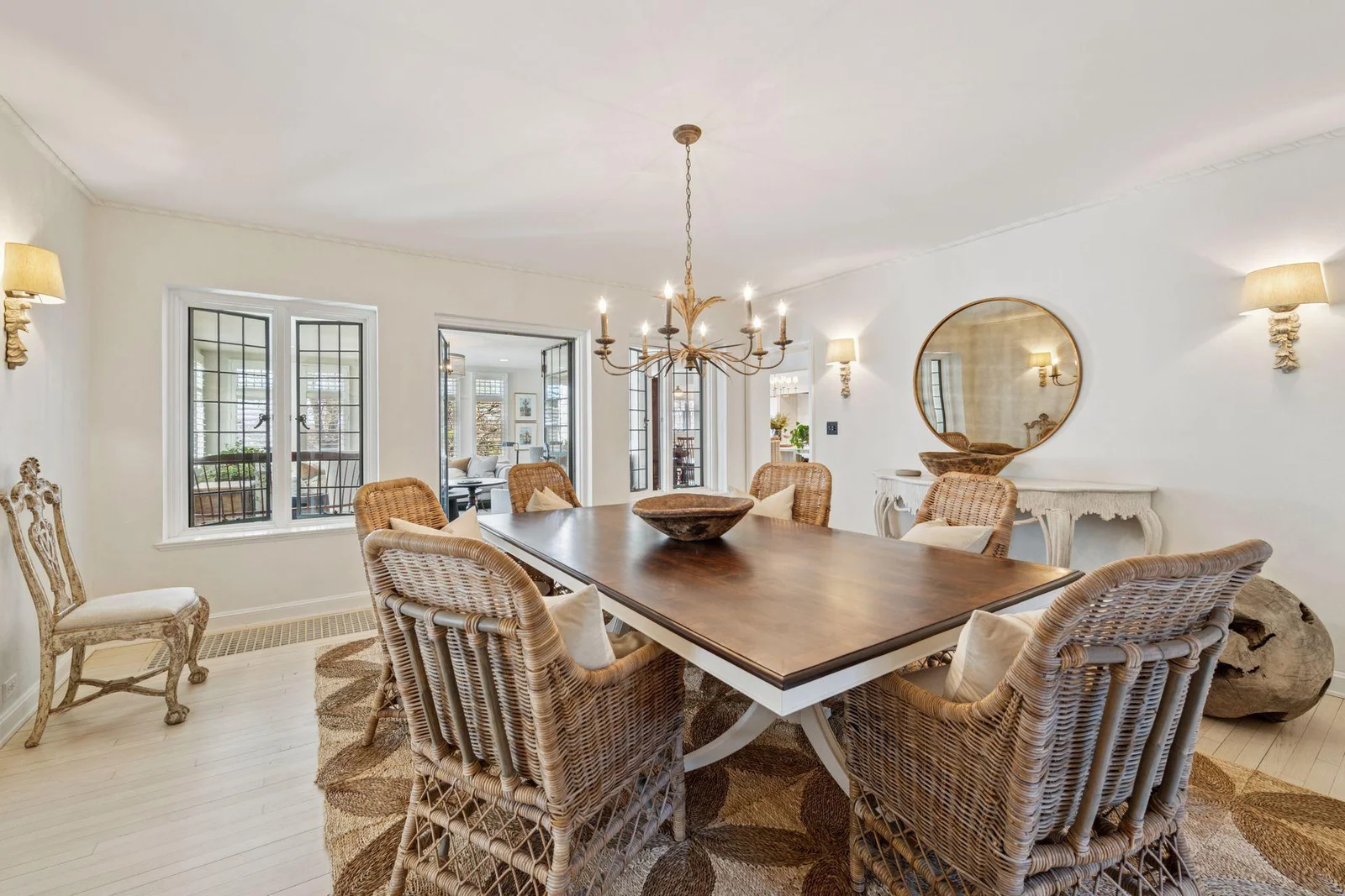 Leaded glass windows and french doors open to the main level family room from the formal dining room.