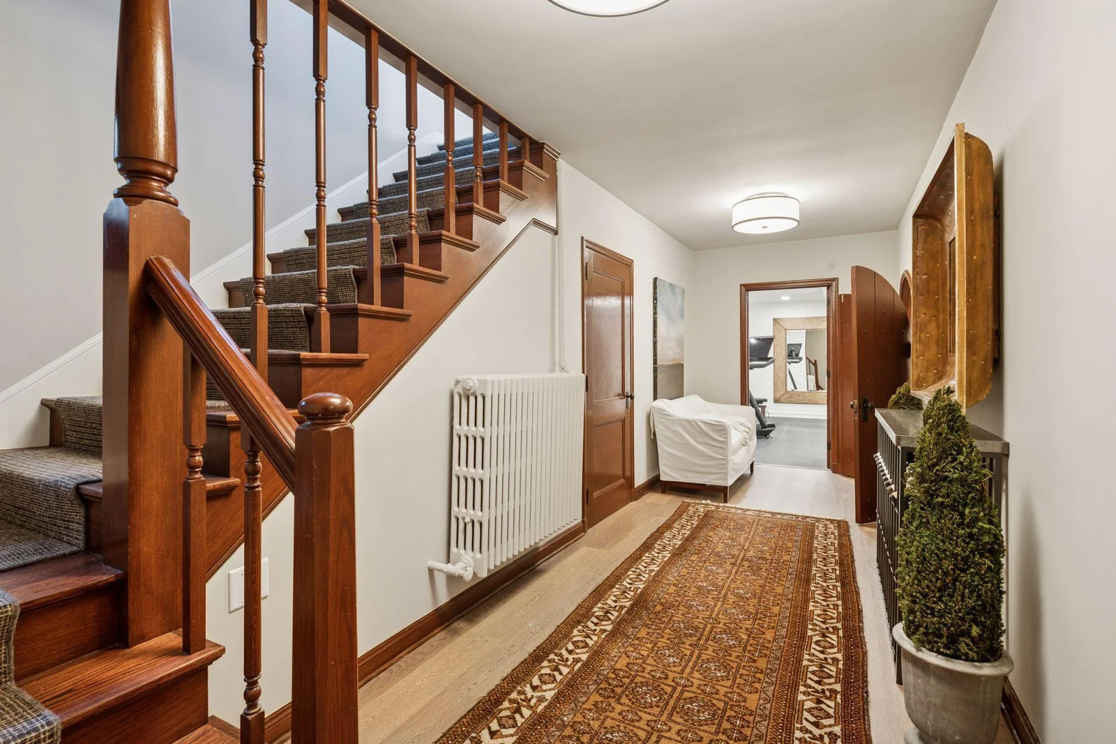 A beautiful front staircase leads to the lower level hall and living areas.