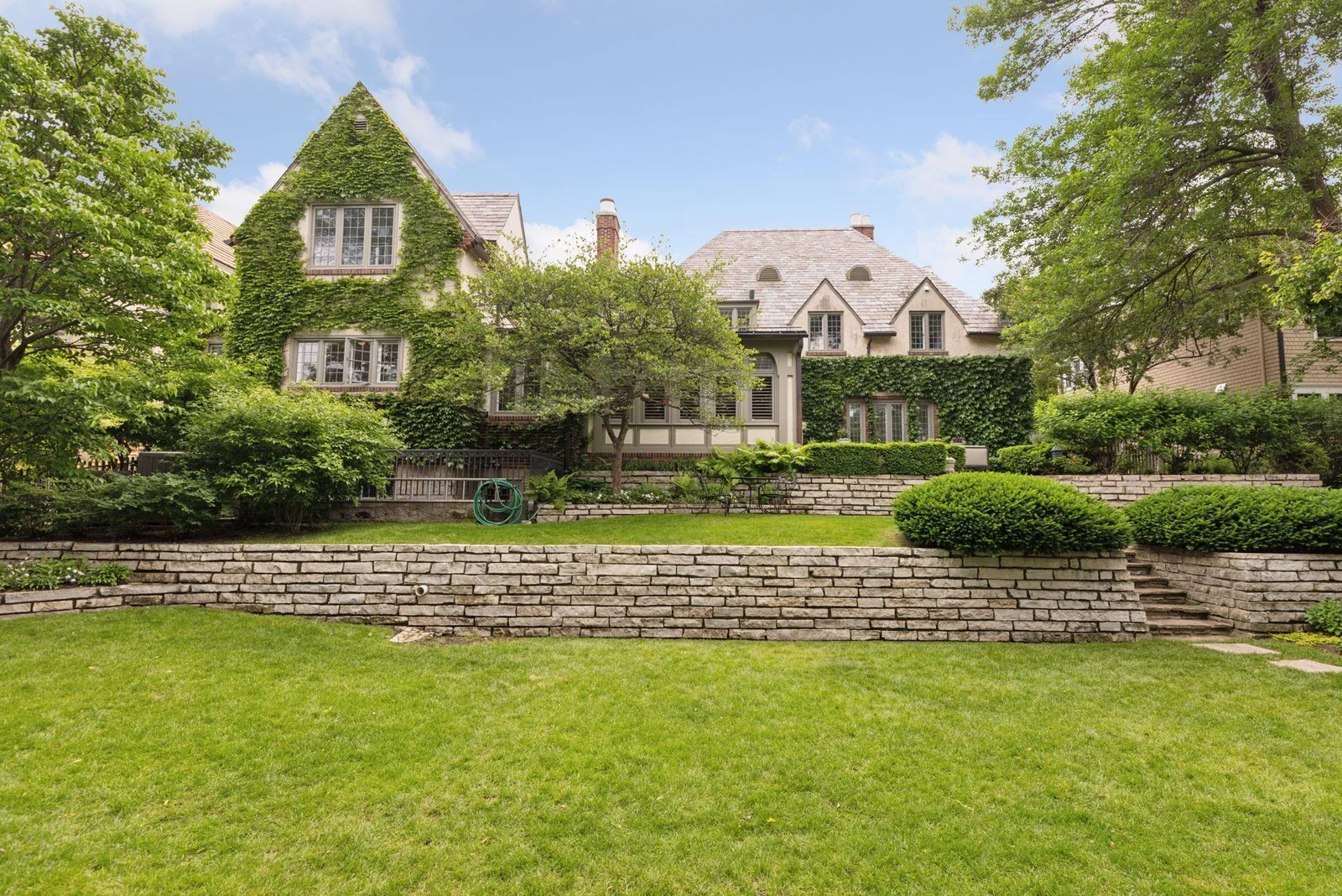 Gorgeous double lot with a wide, flat lawn, terraced upper lawn, and hot tub area.  Privacy provided by perimeter fencing and landscaping.