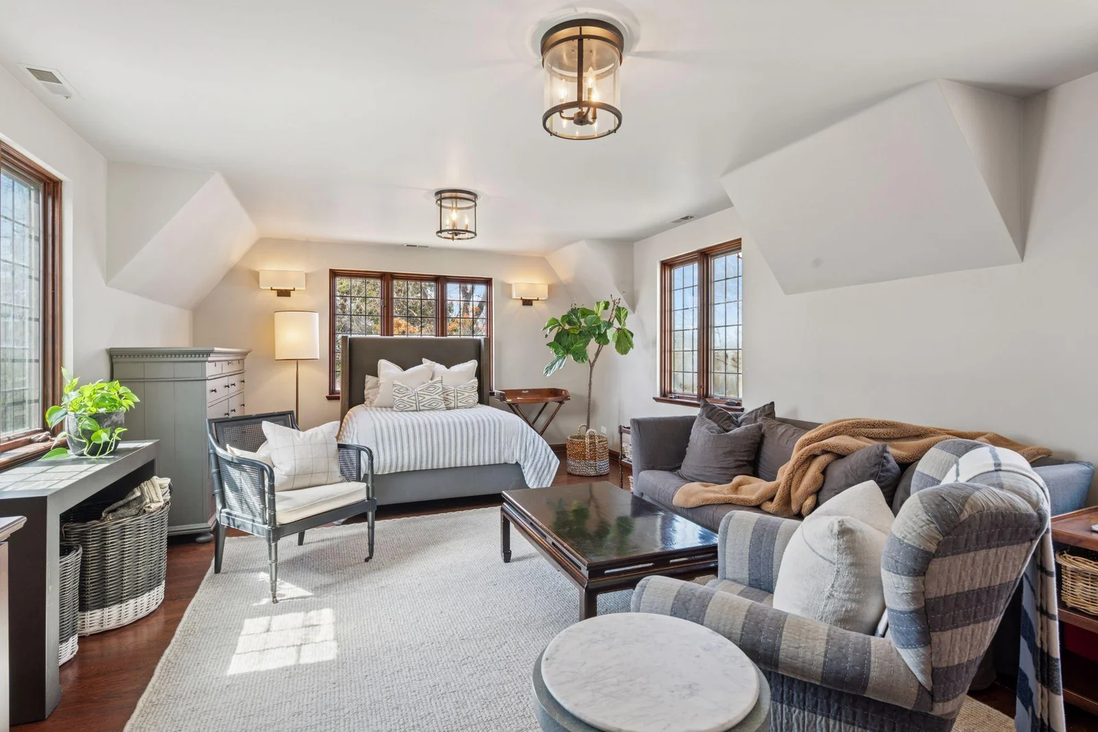 The spacious fifth bedroom provides plenty of space for a lounge area and features three sides of windows with sunset and seasonal lake views.  Great option for an upper level media room, studio, or office.