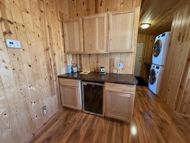 Extra cabinets and beverage fridge are adjacent to the kitchen