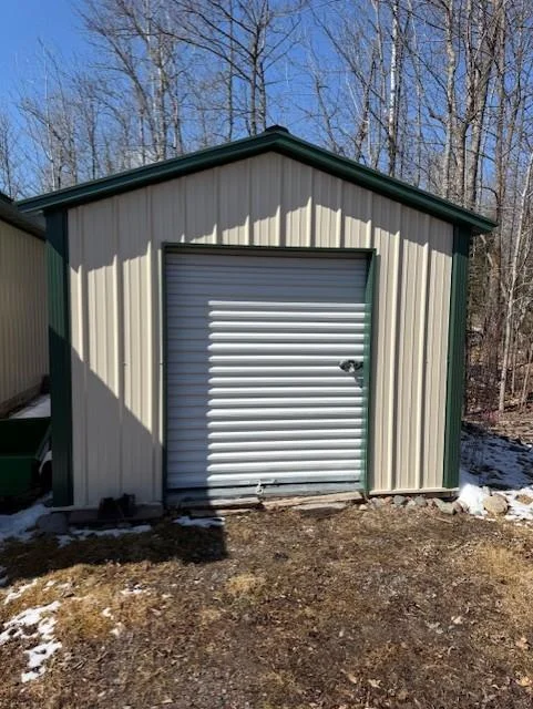 10x16 storage shed with metal roll-up door.