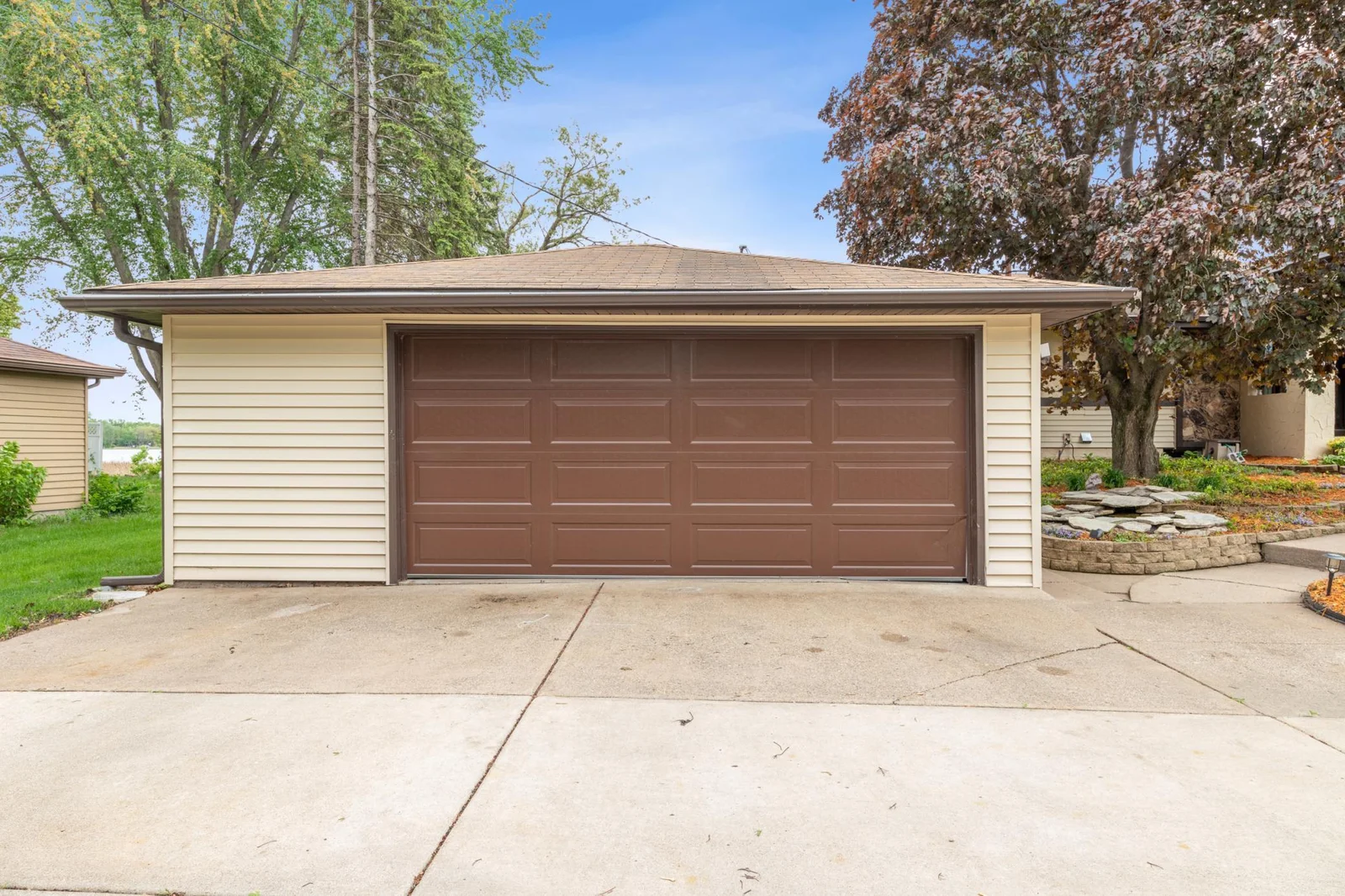 Spacious 2 car garage with a large concrete driveway