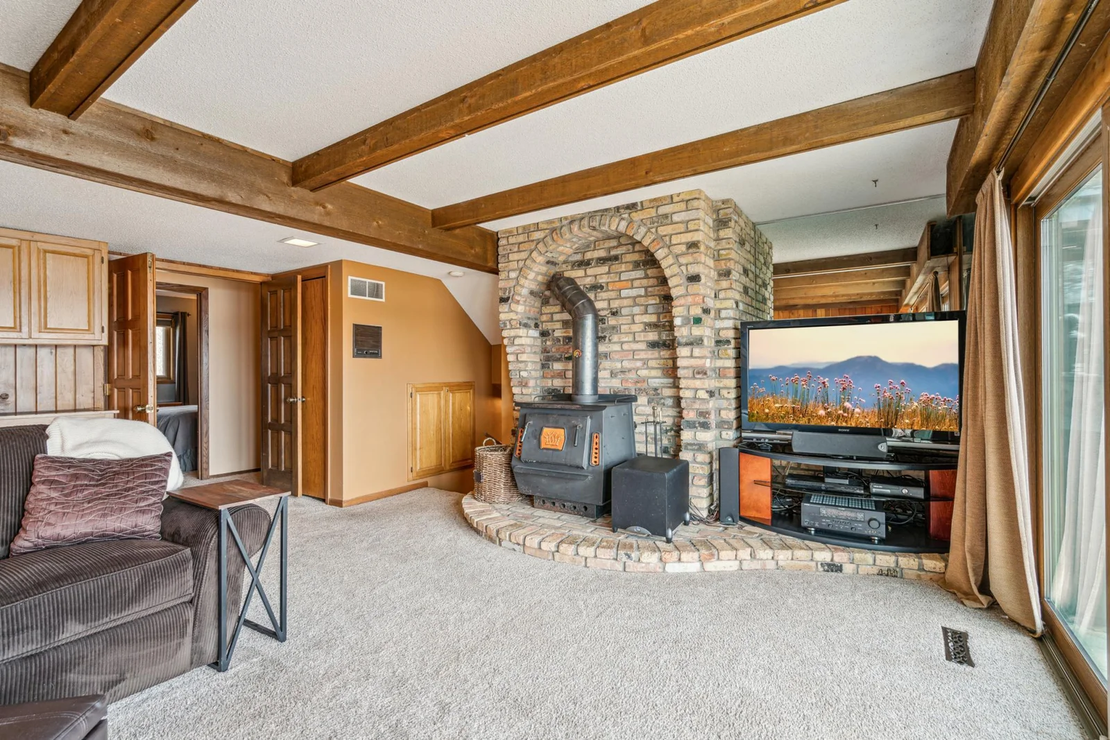 Lower level family room with a cozy wood burning stove and views of Ham Lake
