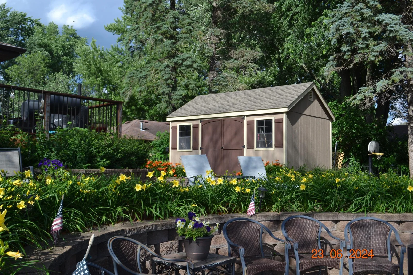 Expansive perennial gardens and shed overlooking the entertaining built-in firepit