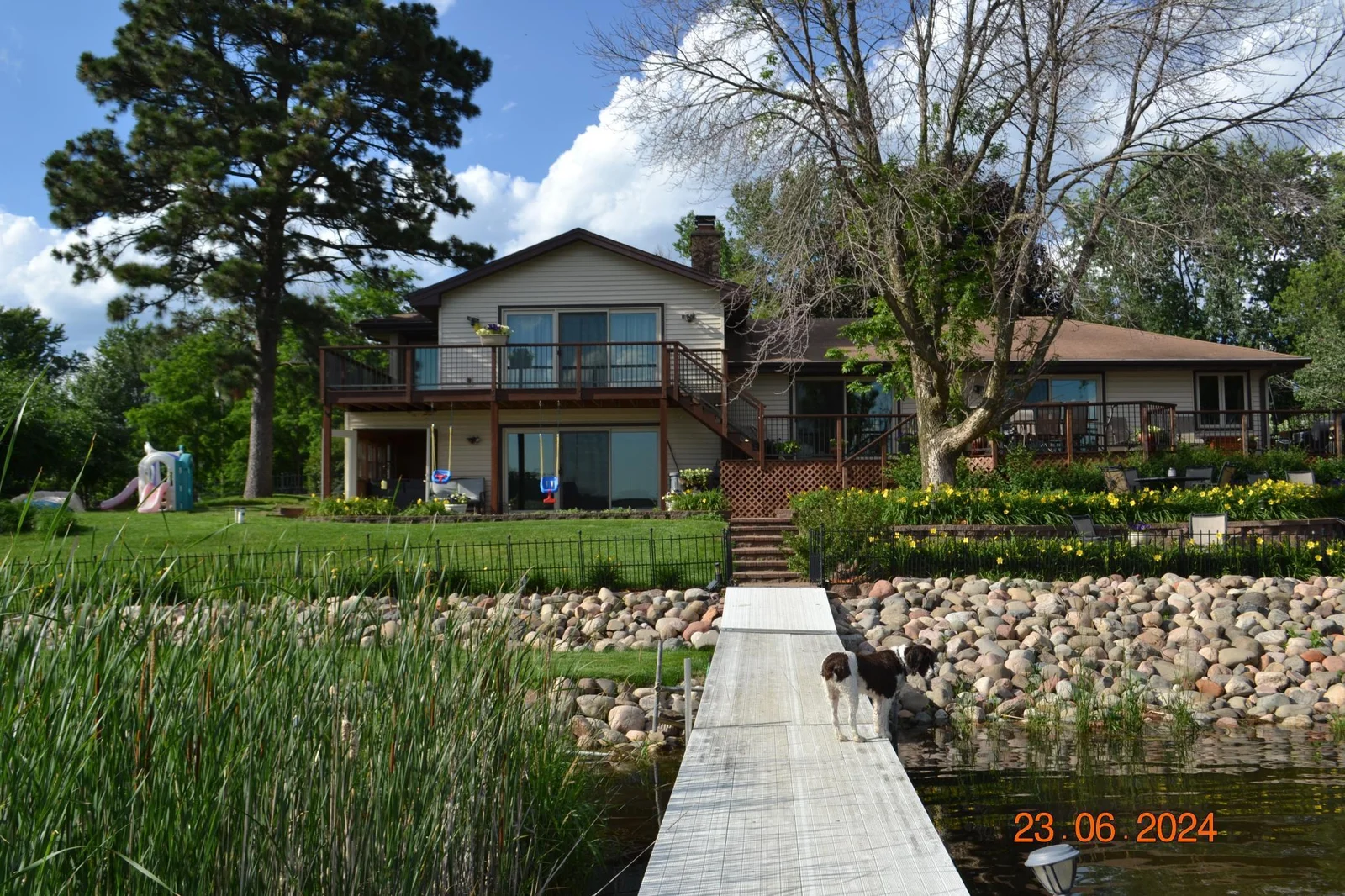 Well maintained landscaping and lawn overlooking picturesque Ham Lake