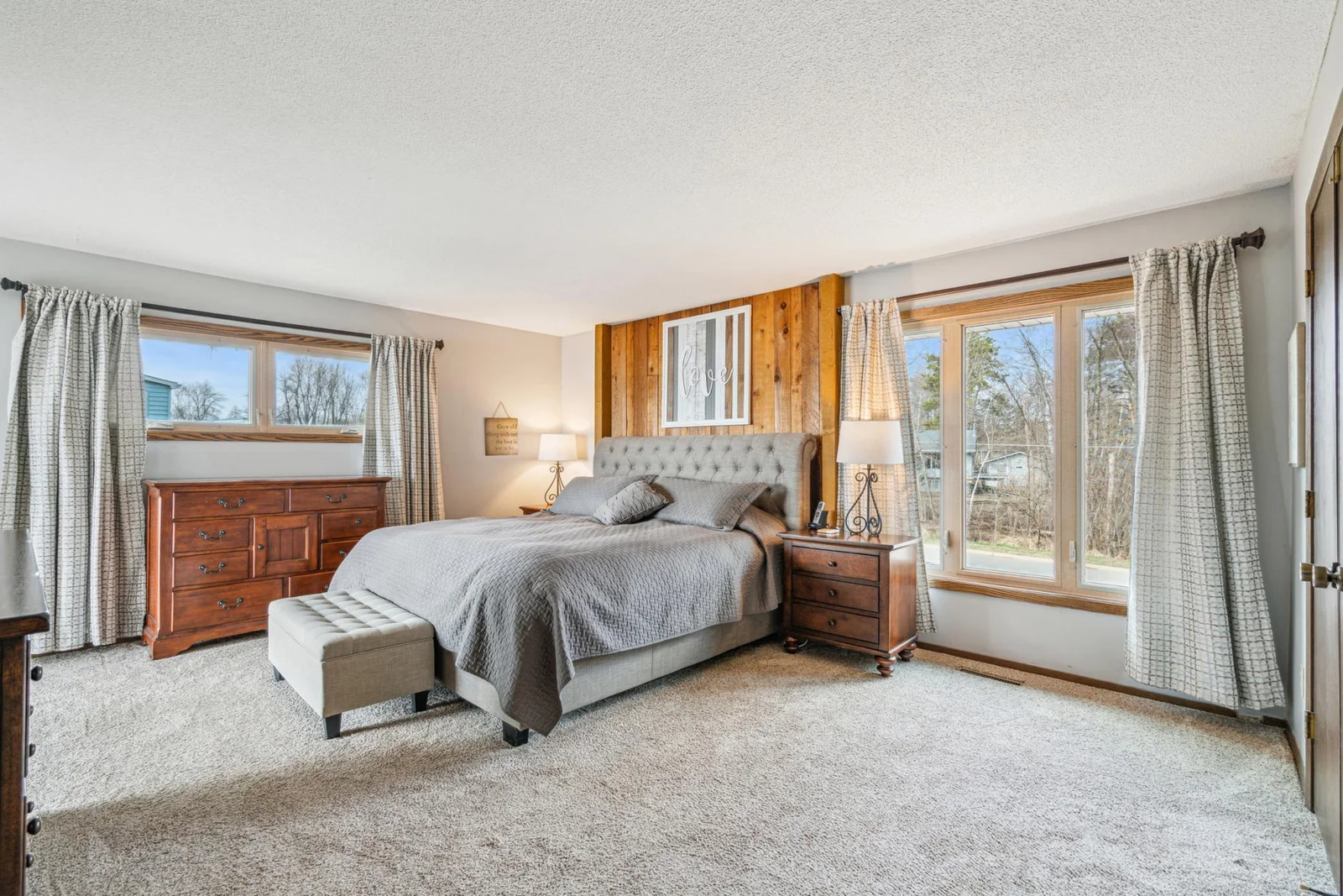 Upper level owners suite with plush carpet private 3/4 bathroom and a large walk-in closet