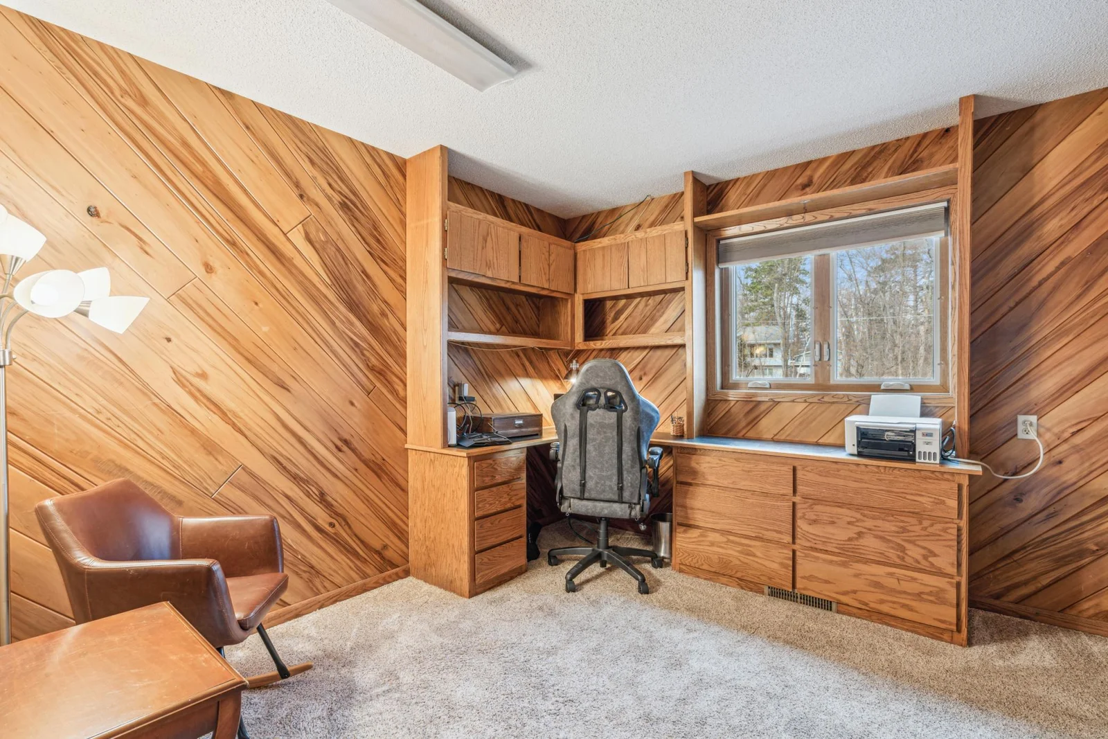 2nd lower level bedroom with plush carpet and built ins perfect for a home office