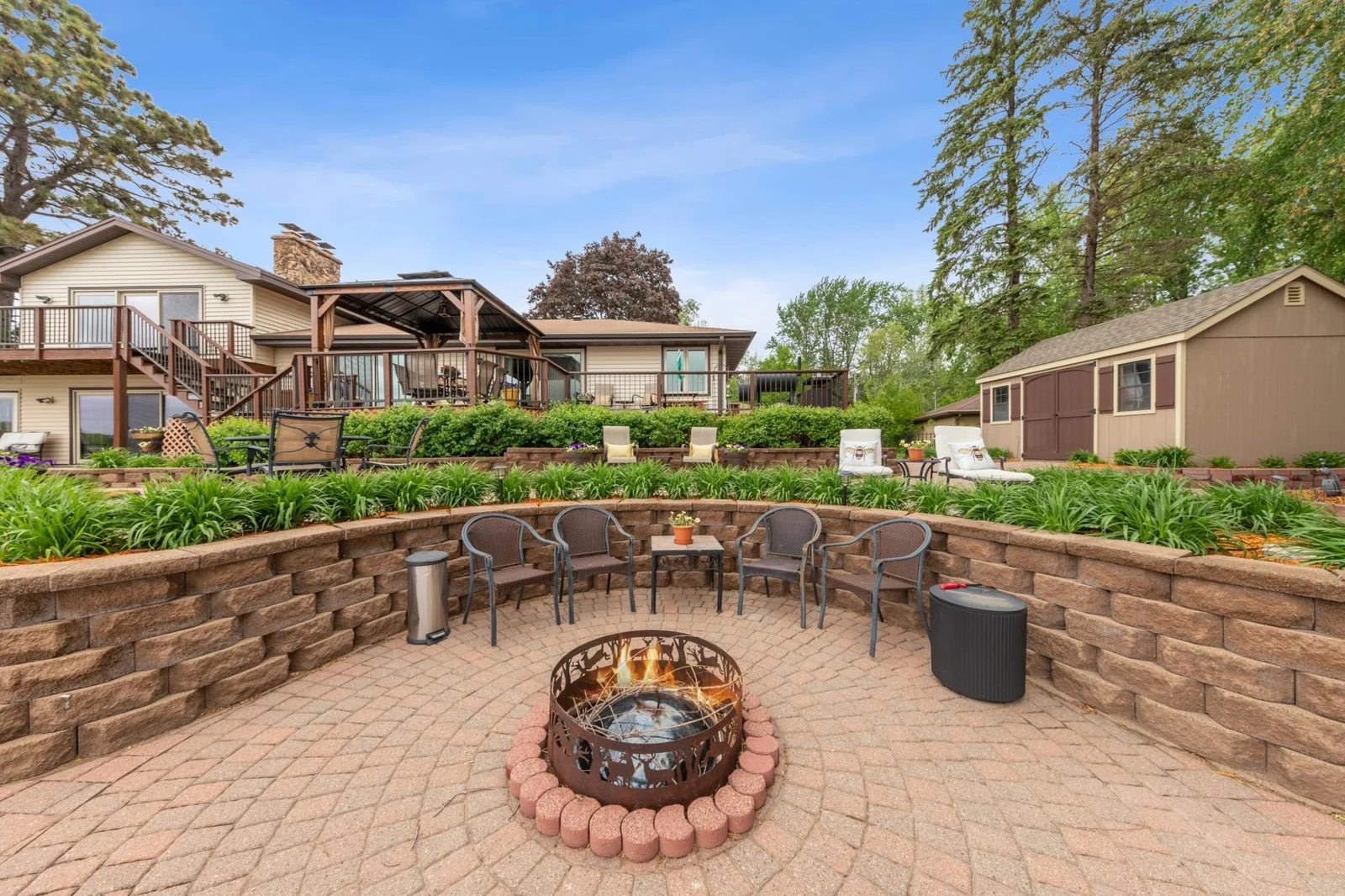 Entertaining patio with a built in bonfire pit and multiple levels of entertaining space