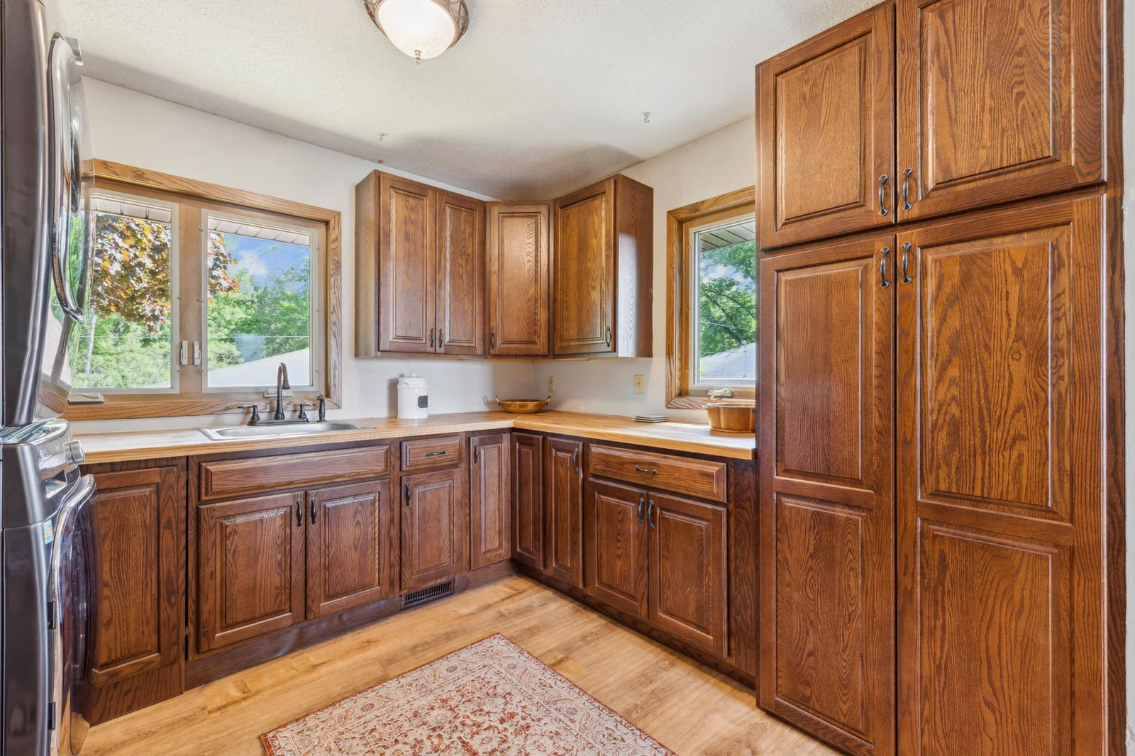 Additional view of the laundry/mudroom with generous cabinetry and countertop space—ideal for folding and organization.