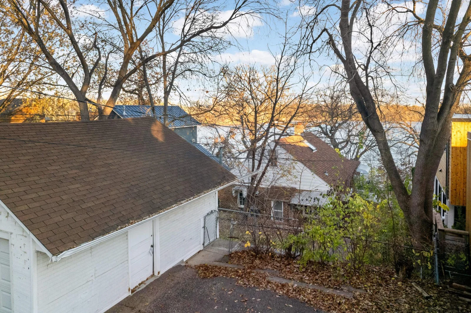 Lot has a two car garage with another parking area next to it.