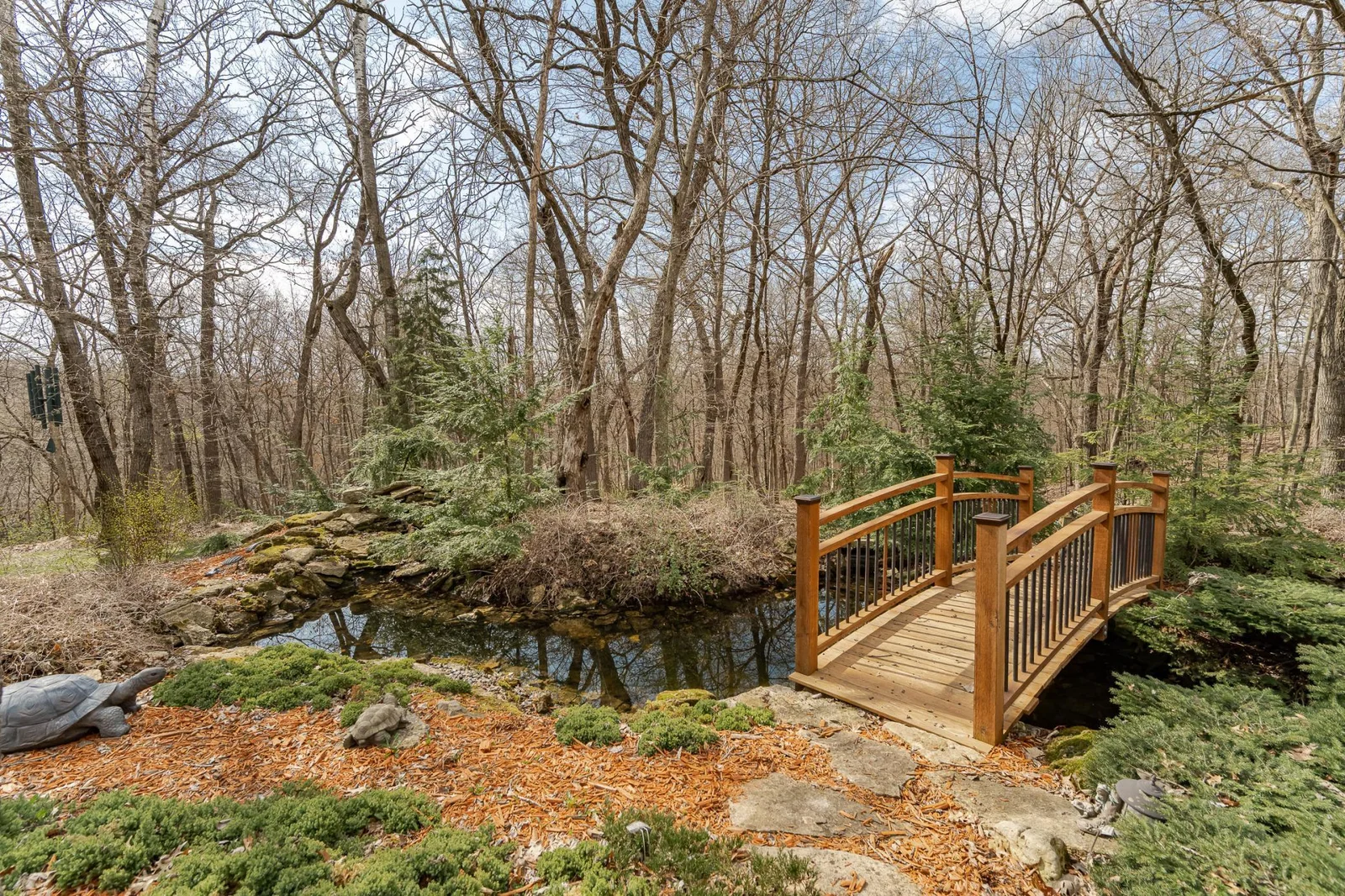Bridge over stream leads to walking path.