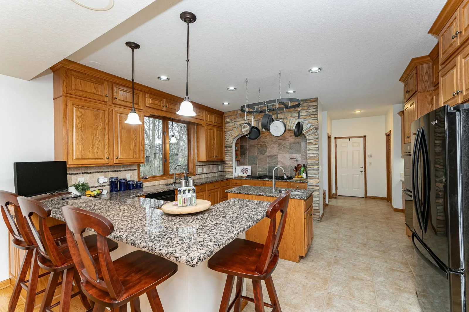 Spacious gourmet kitchen with granite counters and plenty of workspace and storage.
