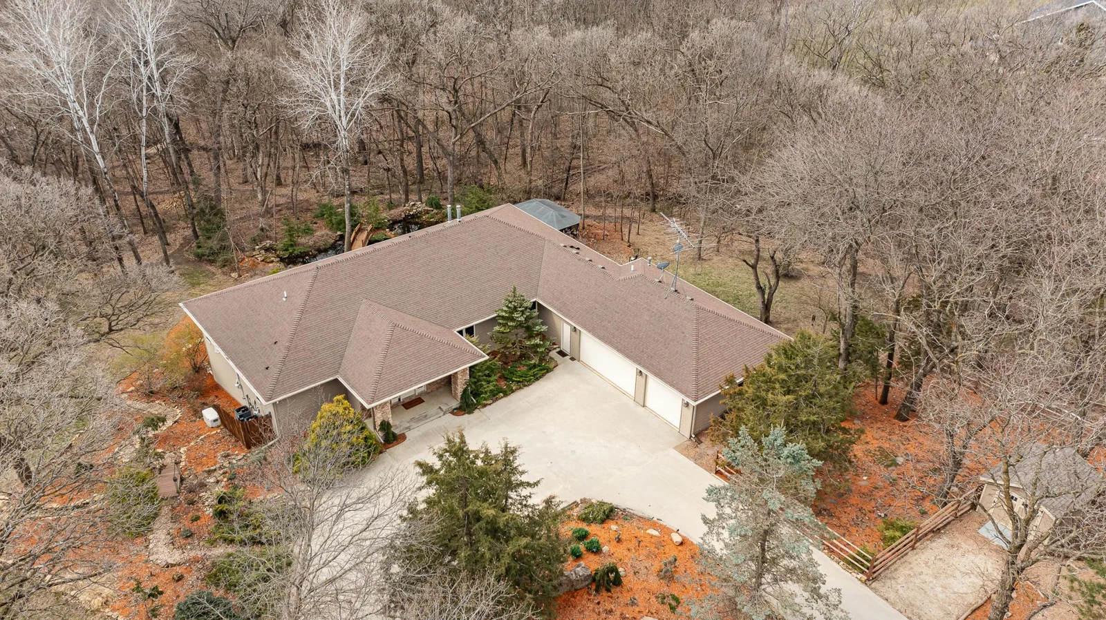 3 car garage. Home surrounded by mature landscaping and woods.