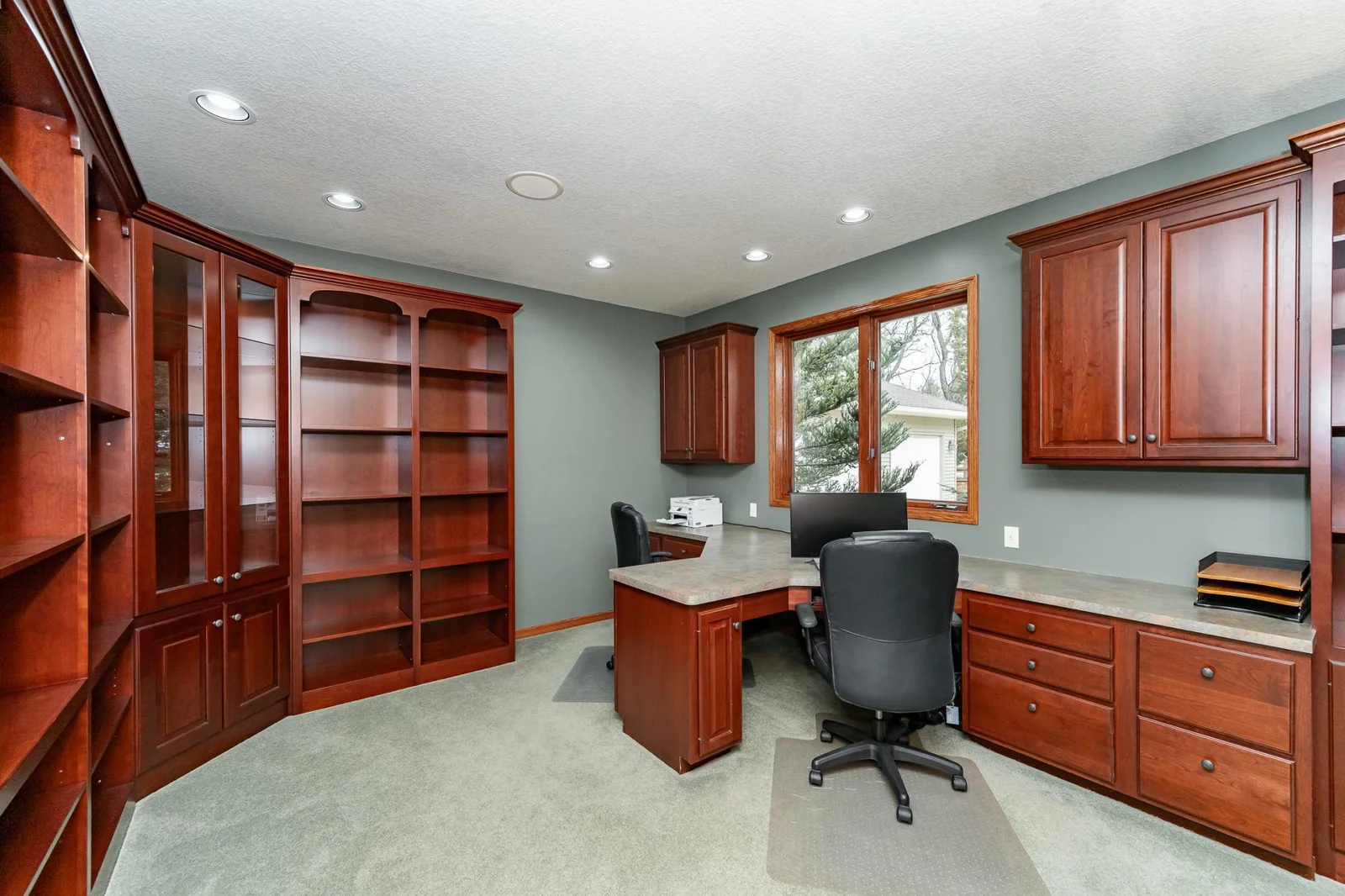 Dedicated office with custom cherry cabinetry.