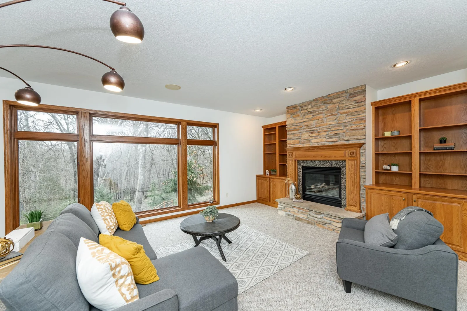 Main floor living room with woodland views.