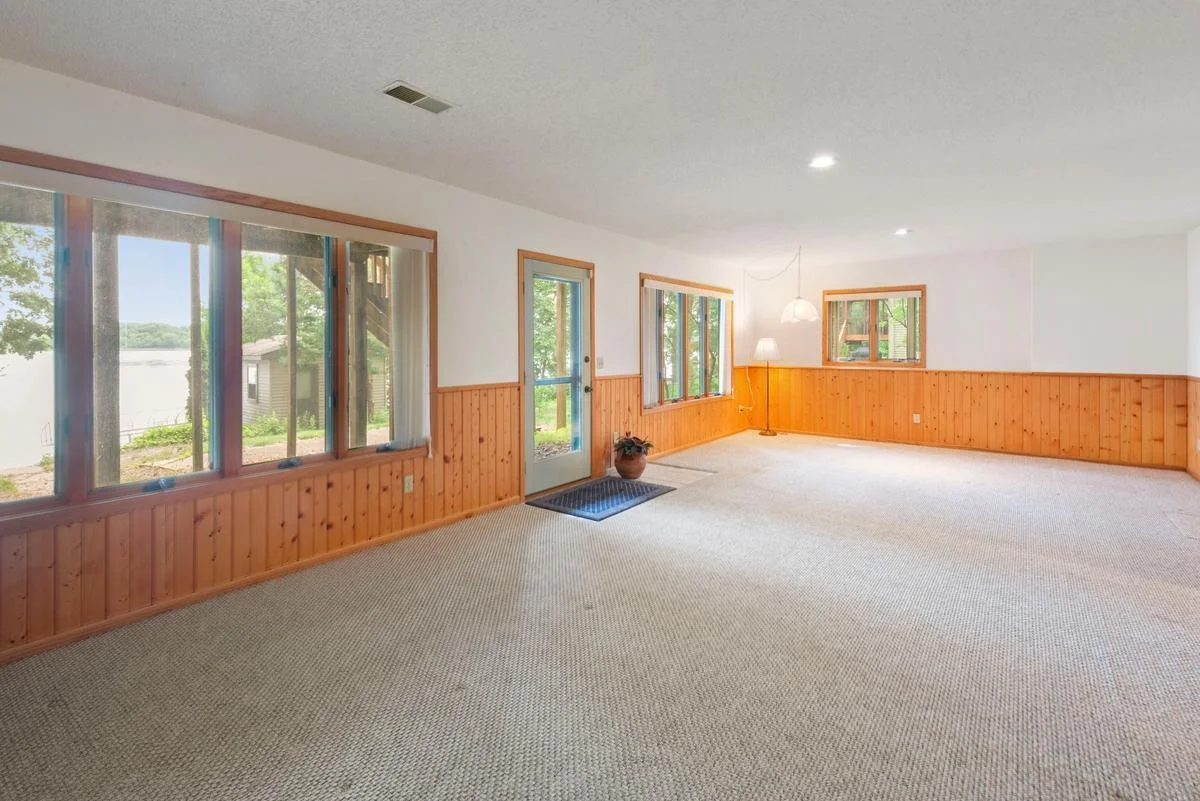 Large windows fill the room with natural light and frame peaceful lake views, while direct access to the patio and lakeshore makes outdoor fun and activities easily accessible.