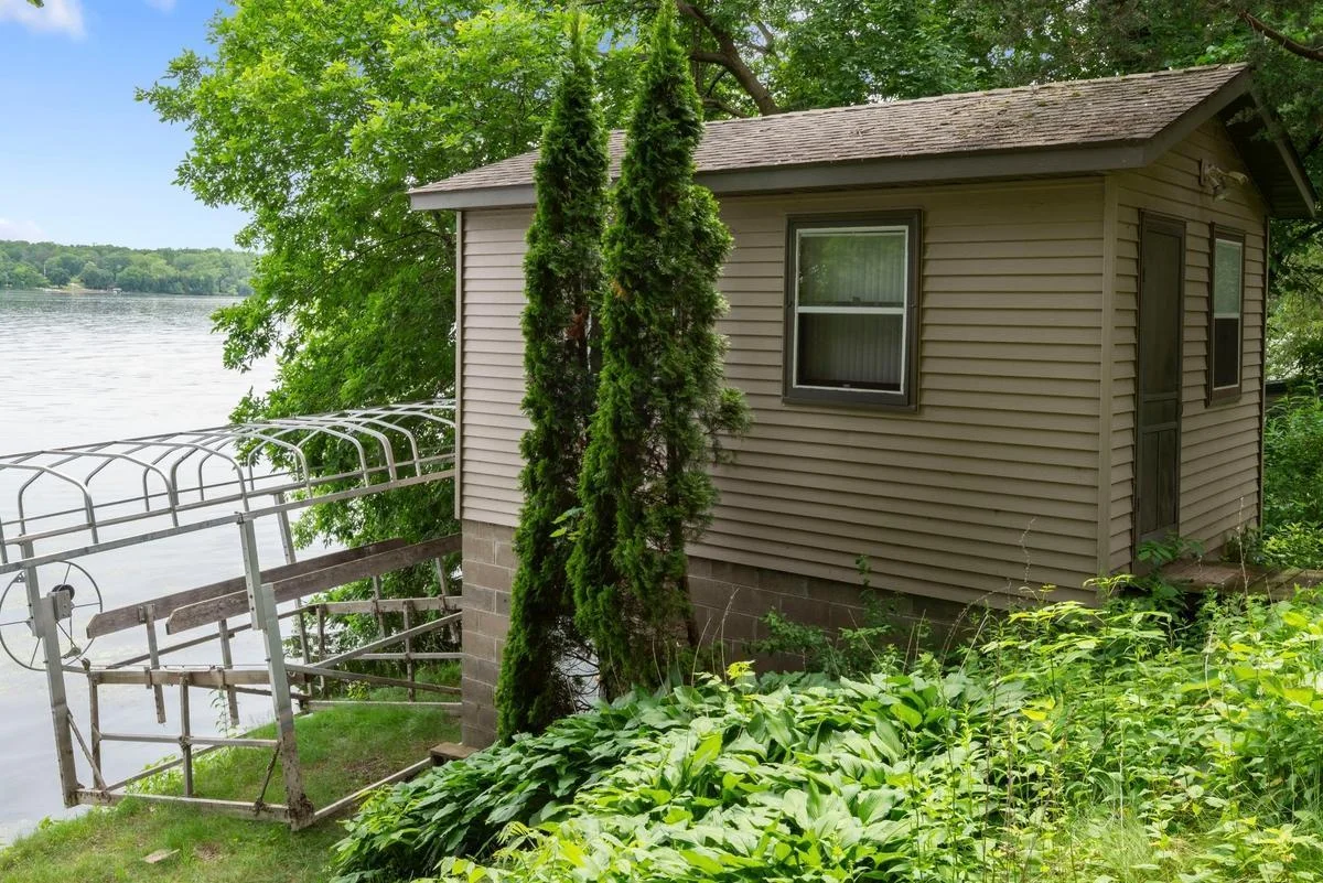 The lakeside bunkhouse features convenient lower-level storage for all your lake gear. The boat lift is included!