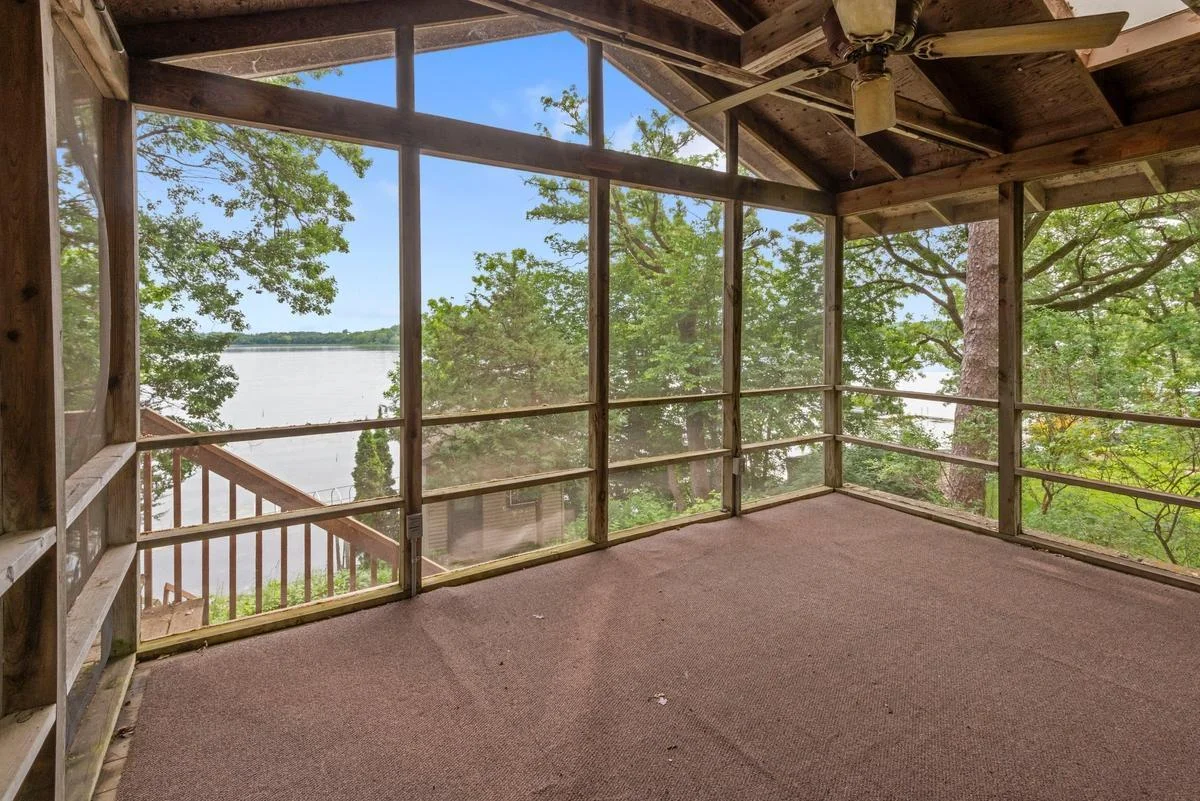 The lakeside screened offers vaulted ceilings and natural wood finishes creating a cozy, rustic feel, making this an ideal space for morning coffee or evening conversations - bug-free!