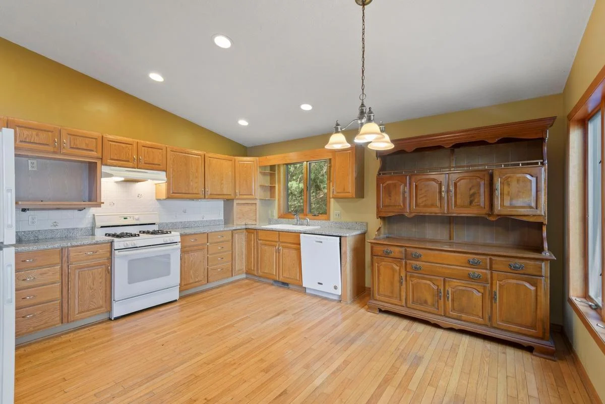 This bright kitchen features granite countertops, ample cabinet space and lake views.