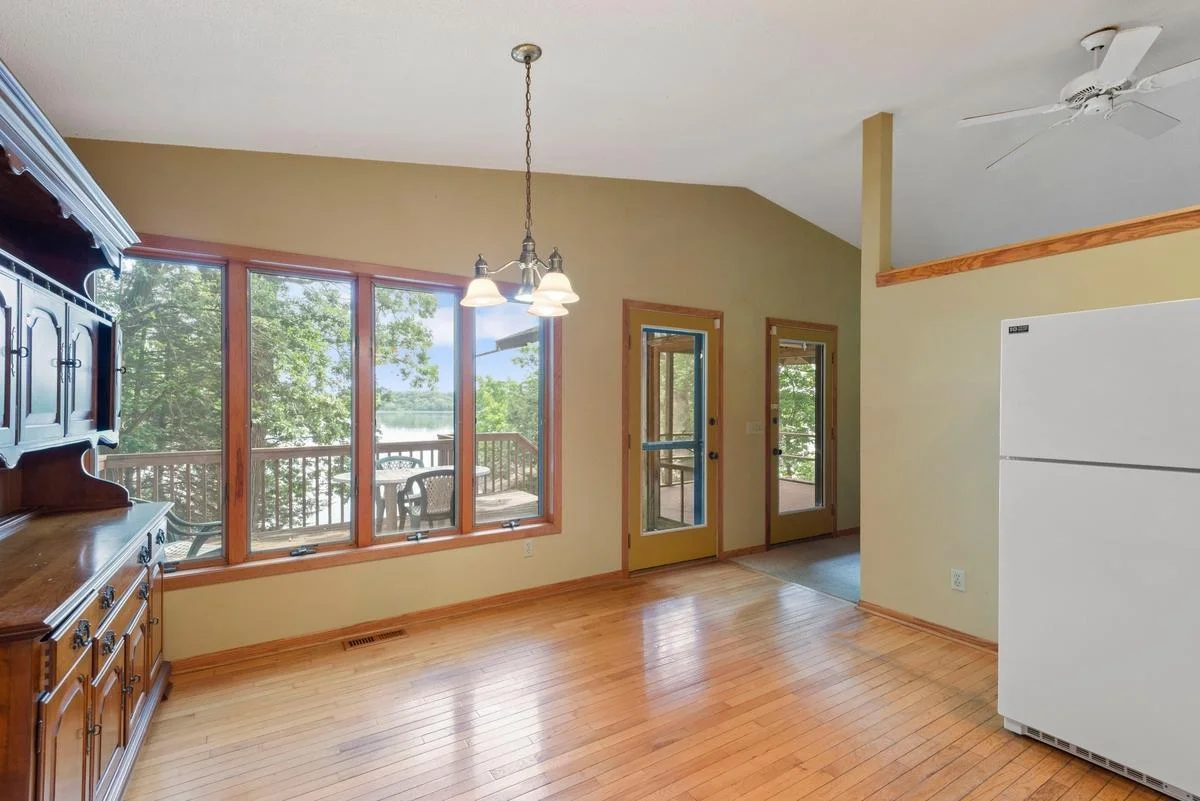 Conveniently access the lakeside deck directly from the kitchen and adjacent screened porch—perfect for easy indoor-outdoor entertaining.