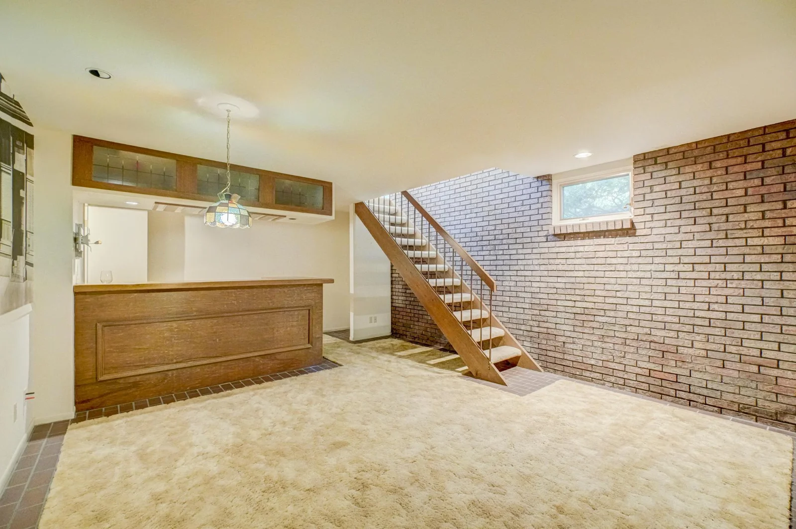 The lower level is designed for entertaining with a dedicated bar room featuring a wet bar and ambient lighting, a wine cellar, sauna, and double staircases for convenience.
