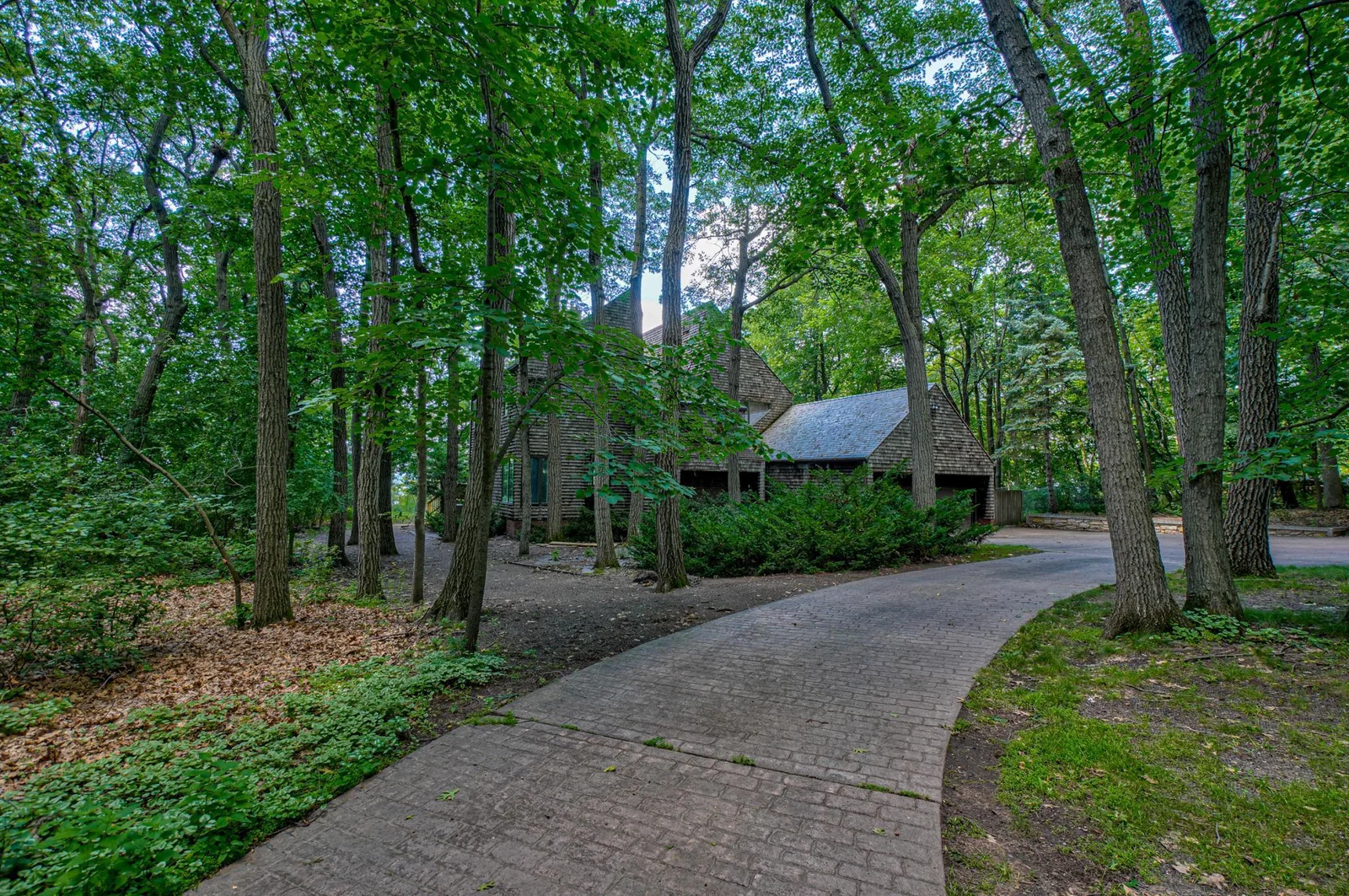 A solid concrete driveway leading to the attached and detached garages offers functionality with plenty of space for your vehicles & toys!