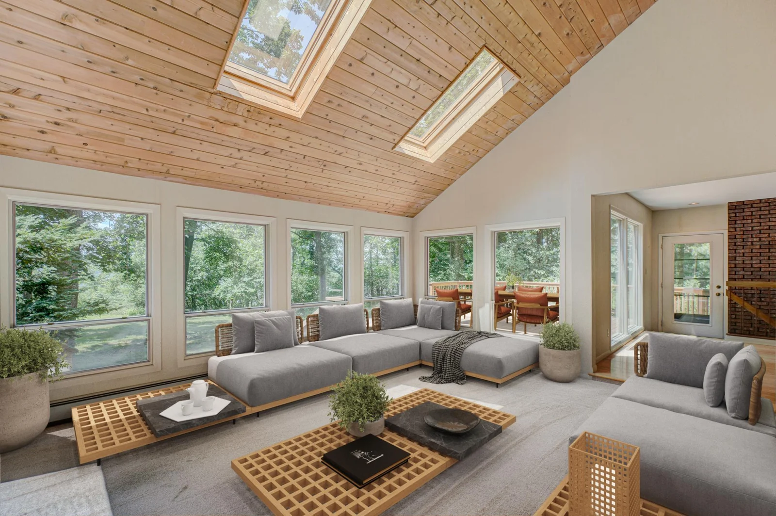 The sun-drenched four-season porch and walkout deck provide front-row seats to river views and life on the water. (virtually staged)