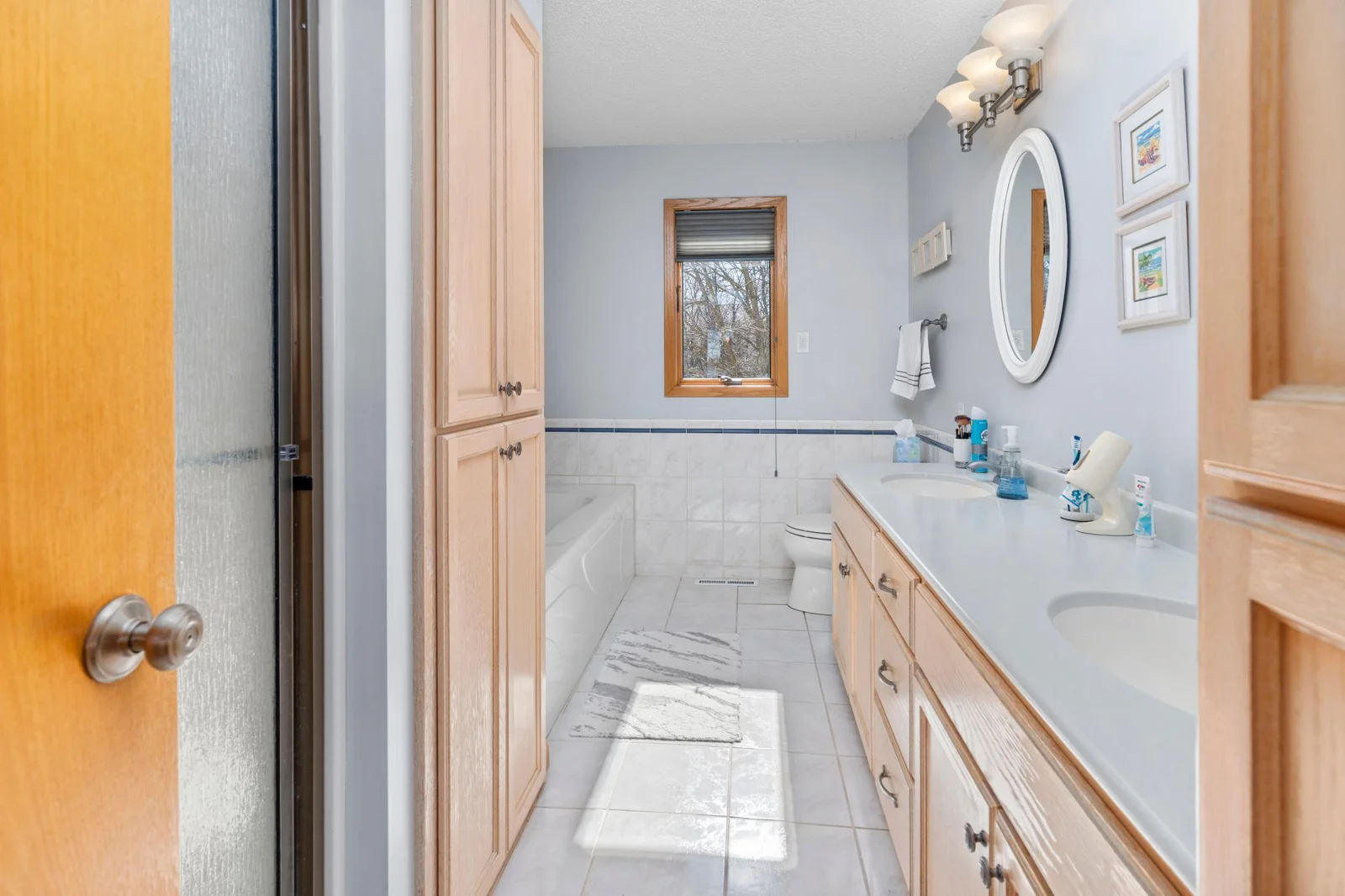Primary bath upper level. Dual sinks, walk in shower, and a bath tub