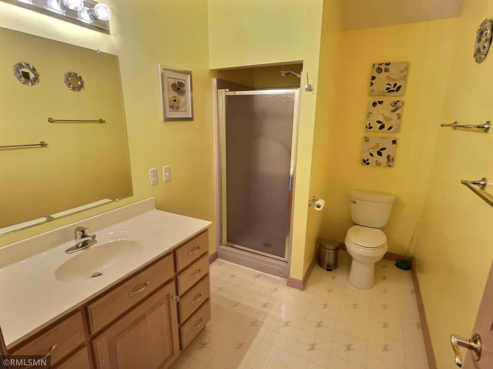Upper level bath which is located between the two upper level bedrooms and adjacent to the upper level sunroom.