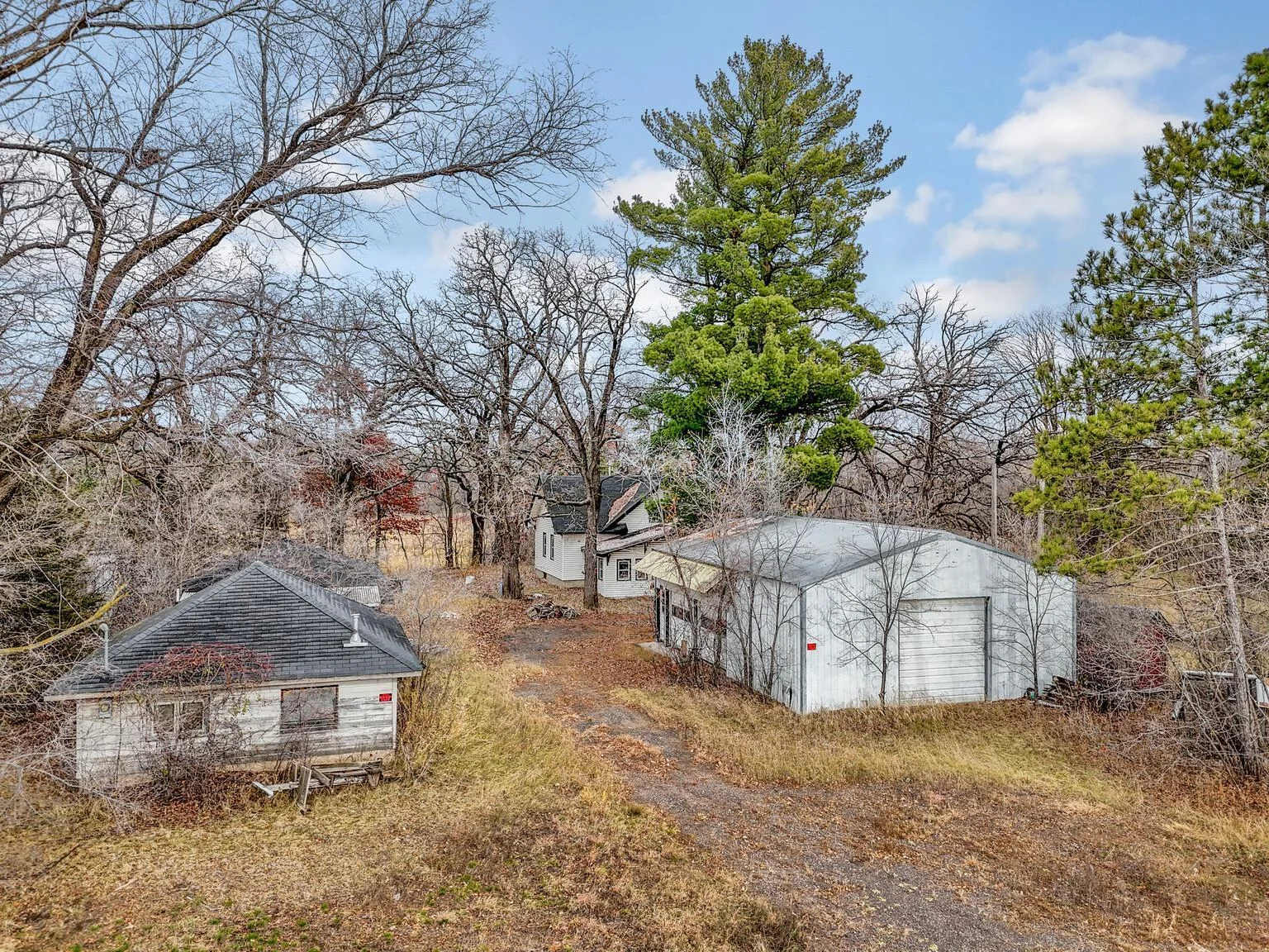 Driveway between shop (left) and pole barn (right)