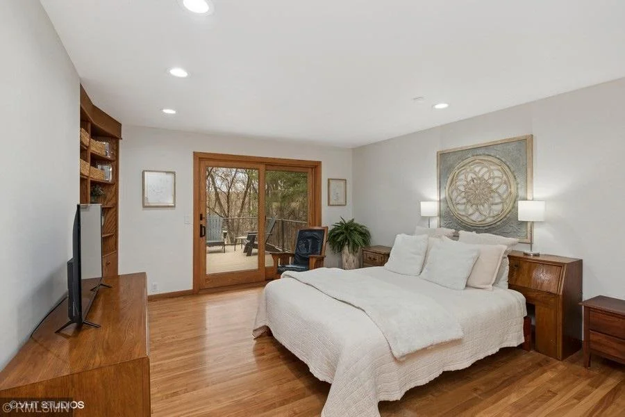 Primary bedroom has wood floors and a patio door that leads the large backyard deck.  Perfect for morning coffee!