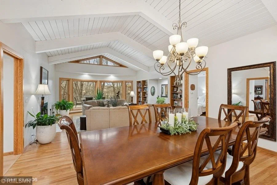 Living room has an abundance of windows allowing for natural lighting and beautiful views of the backyard and river frontage!