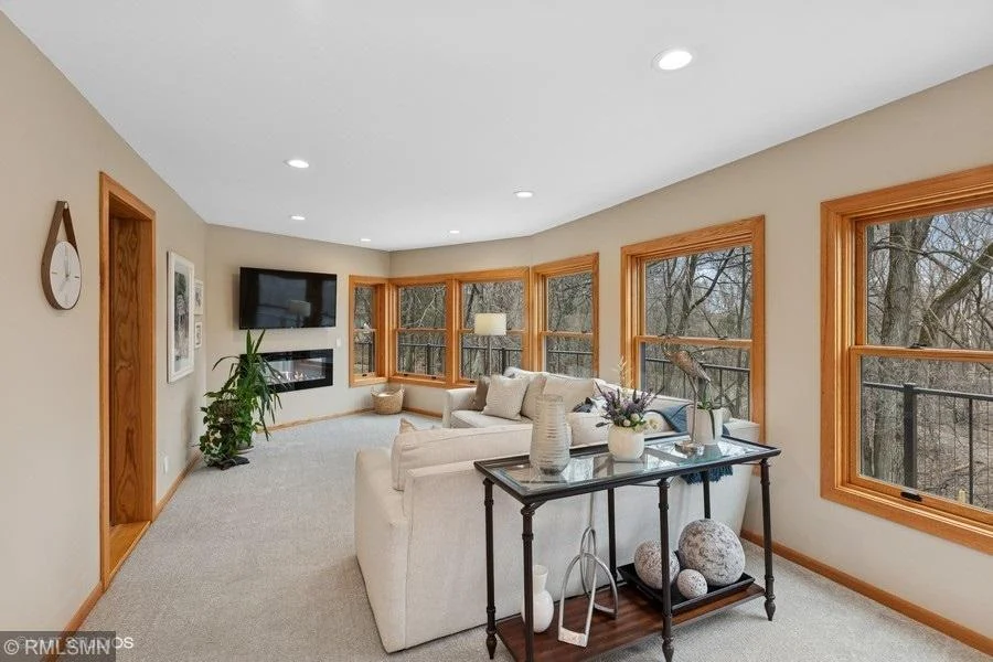 Beautiful sun room with an abundance of windows overlooking the backyard.