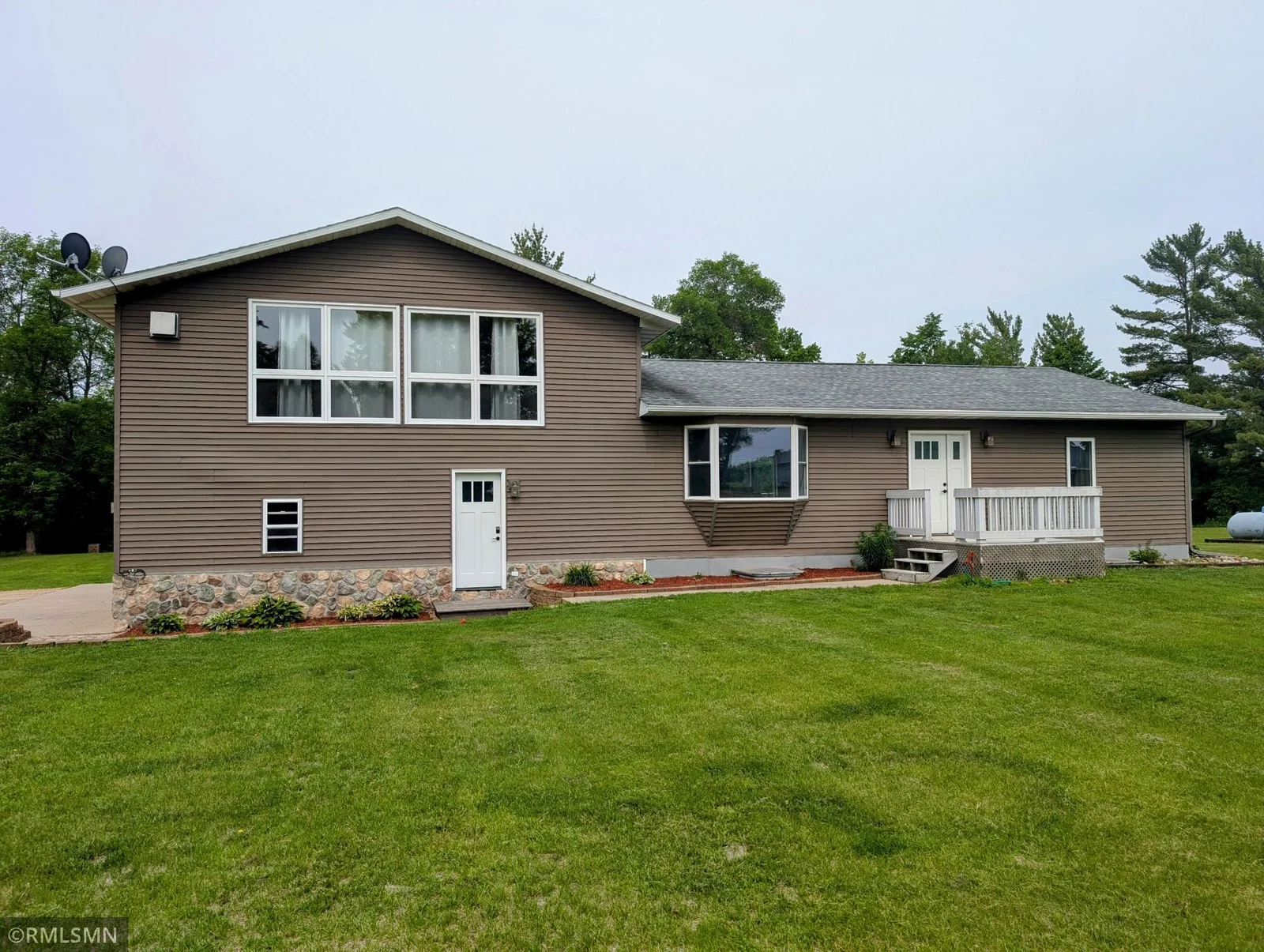 Front of the home. New exterior doors and freshly painted window trim.