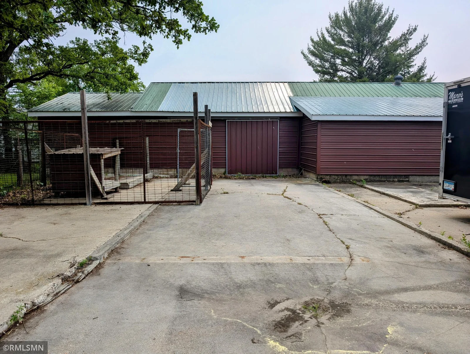Cement slab. Dog Kennel. Side of shed sliding door.
