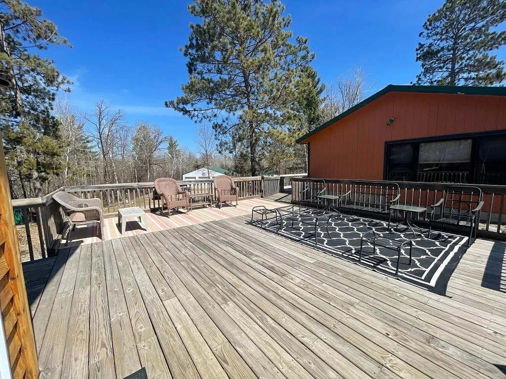Large deck between main home and bunkhouse.