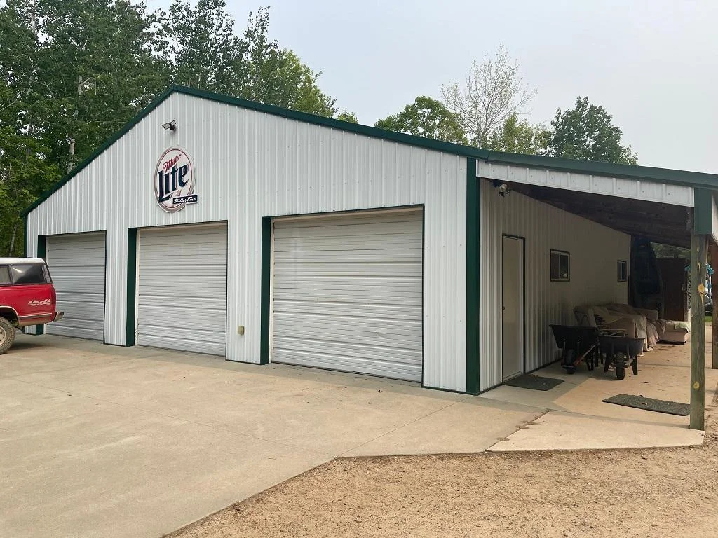 Three stall storage shed with covered patio.